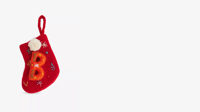 Christmas stocking decorated with colorful lettering and festive motifs, perfect for holiday cheer and gift giving.