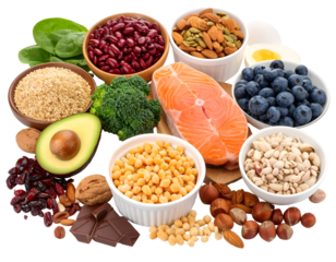 A colorful assortment of healthy foods including fruits, nuts, seeds, and fish arranged together in bowls and on a surface
