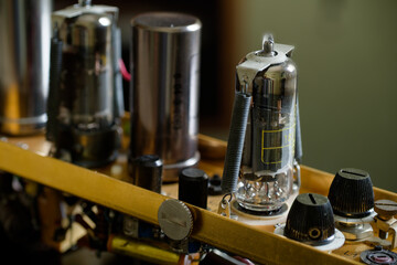 Obsolete vacuum tube amplifier module with old electronic components mounted on a metal chassis