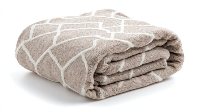 Folded beige blanket with abstract white geometric pattern cast on bright white backdrop