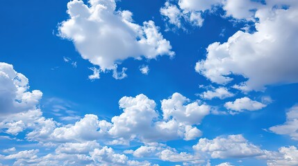 Vibrant Blue Sky with Fluffy White Clouds Overhead at Daytime