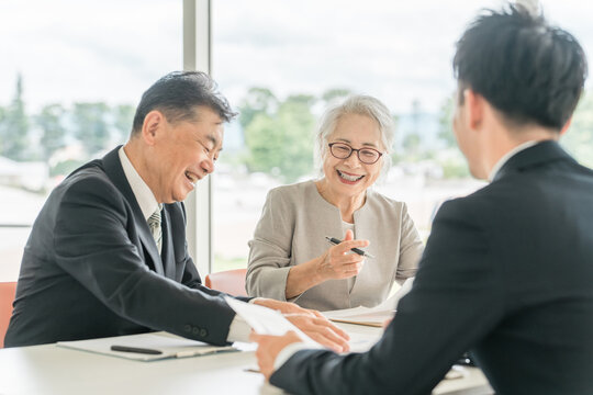 An elderly couple reviewing the proposed documents (asset management, consultation, investment, inheritance)