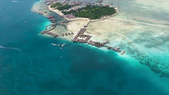 Tropical island Mabul in the blue sea with a coral reef and the beach. Semporna, Sabah, Malaysia.
