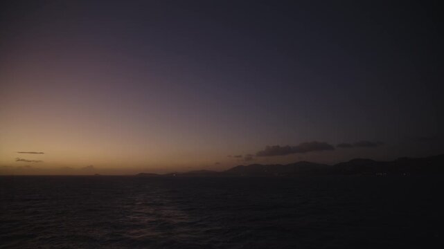 Late evening sunset of the Caribbean sea with St. Thomas, USVI on the distant horizon