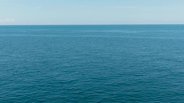 Beautiful white clouds on blue sky over calm sea. Flight over the sea. Indonesia.