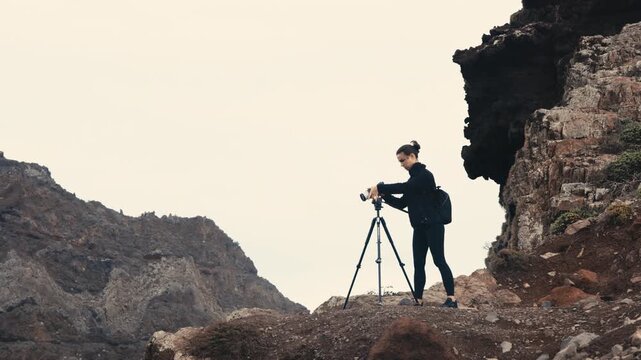 Photographer hiking and capturing nature landscapes with a camera. Concept tourism and outdoor adventure