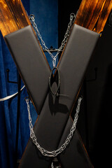 BDSM set. Leather accessories on a wooden cross.