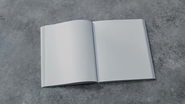 Open blank book lays on a gray textured surface