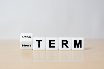 Business investment concept for Flipping of dice for change short term to long term.