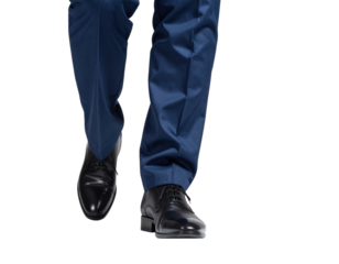 Closeup of a mans legs in a blue suit and black dress shoes walking forward.