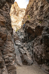 Woman Stands Atop The Rocky Down Climb At The End of Upper Burro Pouroff In Big Bend