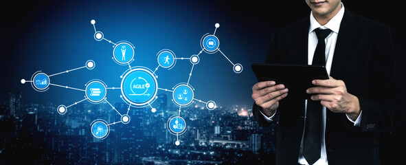 A professional businessman in a suit interacts with a tablet amidst a futuristic digital landscape, showcasing advanced technology and networking concepts in an urban setting. Tessel