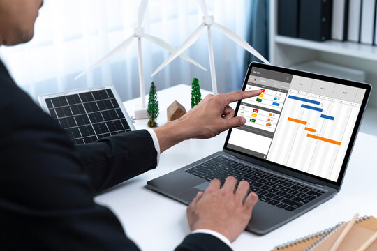 Project planning software for brisk business project management on the computer screen showing timeline chart of the team project