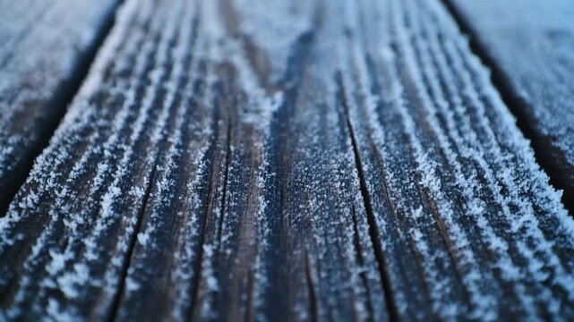 Frost-kissed wood textures: Close-up of frost-covered wood planks, a rustic and textured display of nature's icy art, capturing the serene cold beauty of winter.