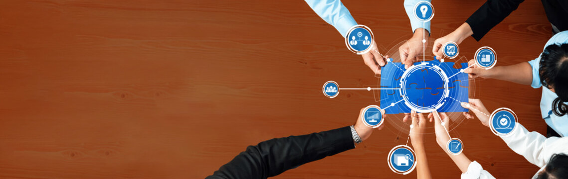 A top view of diverse hands connecting to a digital interface filled with icons representing communication and technology, symbolizing collaboration and teamwork in a modern workspace. Amity - Powered by Adobe