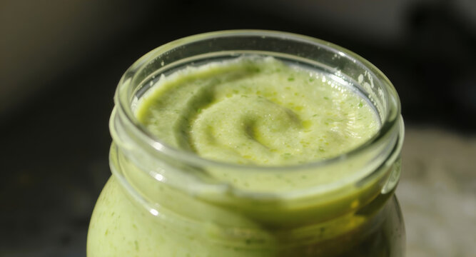 Refreshing green smoothie in glass jar, perfect for healthy eating blogs, nutrition guides, and vibrant breakfast concepts, showcasing wellness and vitality