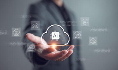 Artificial intelligence cloud computing concept. Businessman holding AI icon in cloud shape with virtual data network. Futuristic technology for data storage, processing, and innovation.