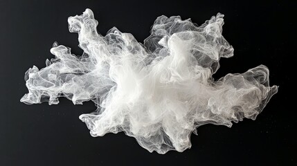 A swirling cloud of white smoke or ink disperses against a solid black background, creating an abstract and ethereal effect.