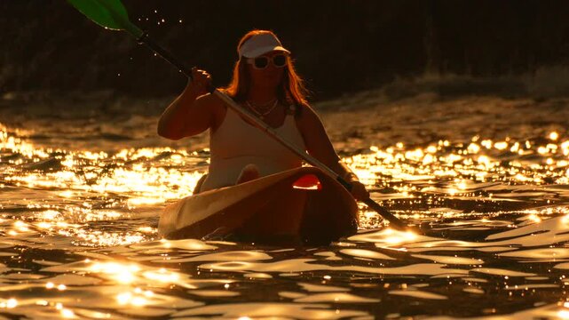 Kayaking sunset water woman paddling kayak during golden hour reflections