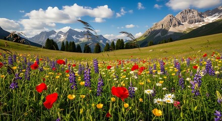 Idyllic Alpine meadow overflowing with vibrant wildflowers under a bright blue sky, mountains in the background