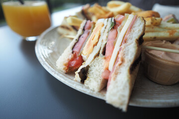 Freshly made sandwich platter with juice served at brunch