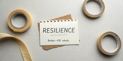Concept of resilience captured with notepad and tape reflecting strength in adversity and personal growth, motivational quote