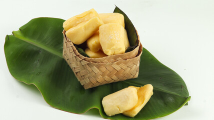 Cassava Tape in a basket on a white background, a traditional Indonesian food, made from cassava with yeast fermentation.
