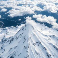 Majestic snow covered mountain peak with clouds and a winding river visible below