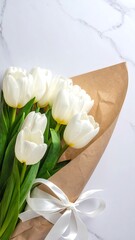 White flowers in a bouquet on a marble surface