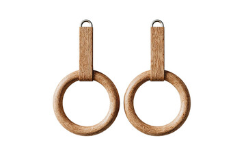 Wooden gymnastic rings hang against a dark background