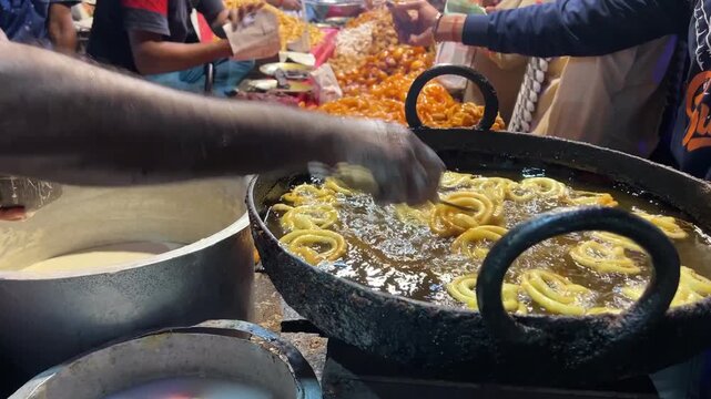 Jalebis prepared by frying in a local shop along the streets of Kolkata during the winter season.