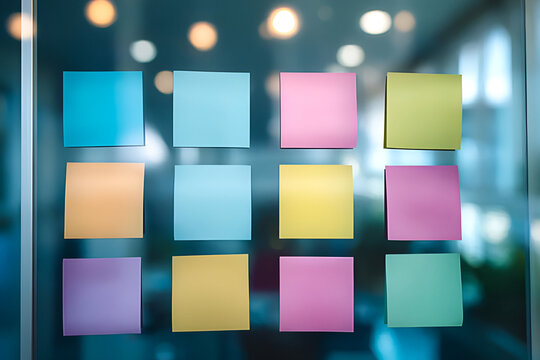 A vibrant display of colorful sticky notes arranged in a grid on a glass surface, symbolizing creativity and brainstorming.