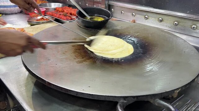 Chicken roll being prepared in Kolkata style in a roadside stall.