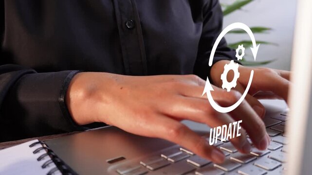 Software or system update. Close-up of a businesswoman's hands working on her computer with an update animation.
