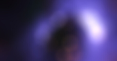 Abstract Blurred Purple and Black Gradient Background with Soft Light Flares and Bokeh Effect, Providing a Vibrant and Dreamy Texture for Design Projects