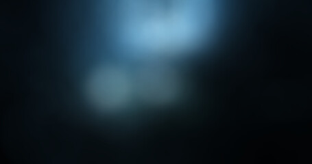 Obraz premium Abstract dark blue background with soft blurred bokeh lights and subtle gradient texture, creating a mysterious and elegant backdrop for modern design.