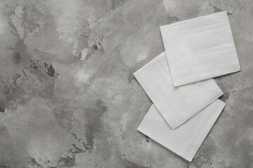 Paper napkins on grey grunge background