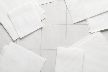 Frame made of paper napkins on white tile background