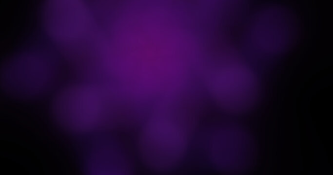 Abstract blurred purple bokeh lights on a dark background, soft focus illumination texture for festive and vibrant design projects