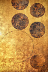 A metallic golden wall with embossed circular patterns creates an elegant surface, ideal for luxury interior design.