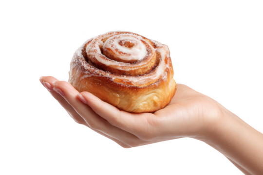 Cinnamon roll on hand isolated on transparent background
