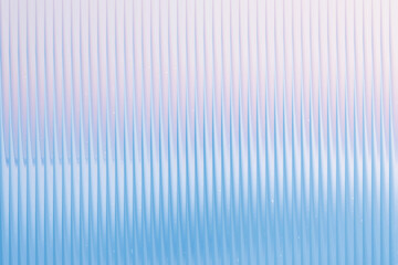 Abstract vertical corrugated surface with a blue and white gradient