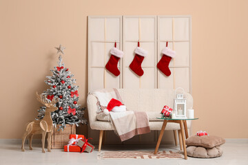 Interior of living room with sofa, Christmas tree, Santa socks, lantern and gift boxes on table...