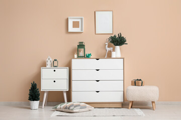 Interior of living room with Christmas lanterns, gift boxes and fir tree branches in vase on...