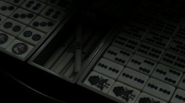 Traditional Mahjong Tiles Set with Circle Dots and Bamboo Sticks Arranged in Wooden Box