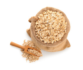 Sack with raw oatmeal and wooden scoop isolated on white background, top view