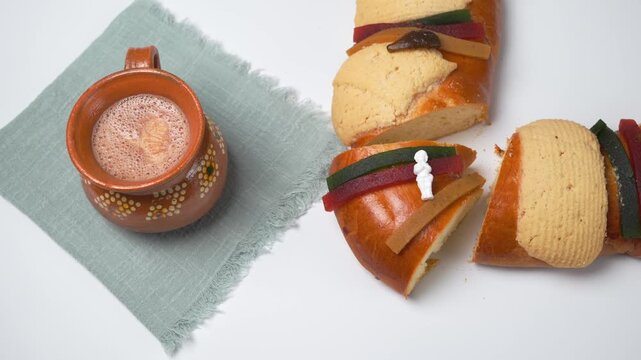 King cake with a plastic figure representing the baby Jesus on top, Mexican Rosca de reyes traditional bread