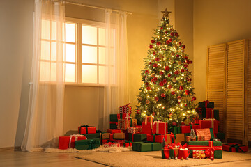 Interior of festive room with Christmas tree, folding screen and many gift boxes at night