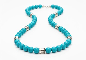 Obraz premium Striking turquoise beaded necklace featuring silver metal spacers, isolated on white.