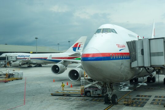 Malaysia Airlines Boeing 747-400 jumbo jet prepares for passengers to board, as ground crew prepares the plane for the flight  in KLIA, Sepang, Malaysia.